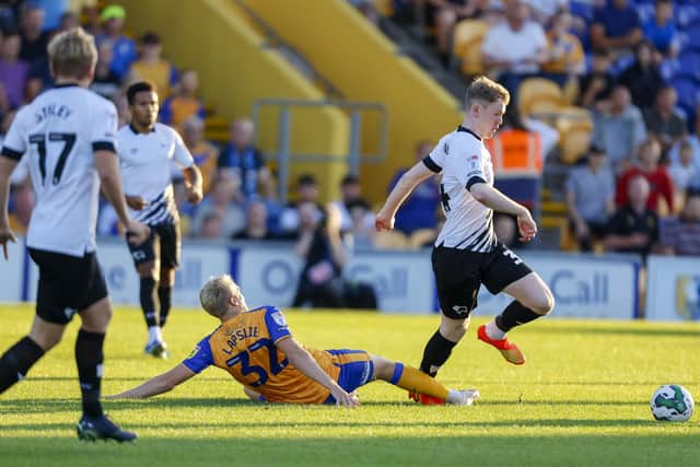 Mansfield Town midfielder George Lapslie gets the tackle in during the Carabao Cup first round match against Derby County FC at the One Call Stadium
Photo Credit Chris HOLLOWAY / The Bigger Picture.media