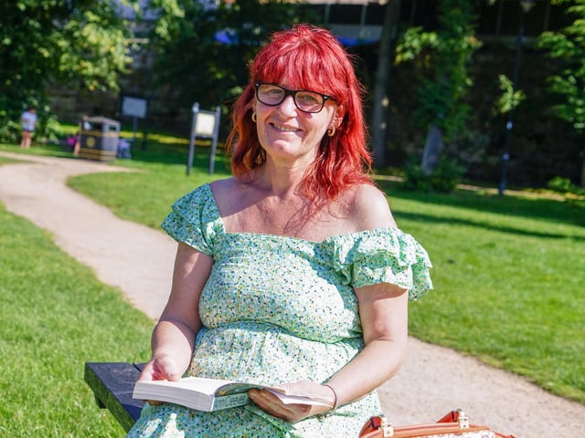 Mansfield Titchfield Park. Teresa Dent, reading a book in the sunshine.