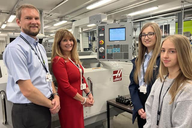 The college’s head of engineering Ben Toule shows Kathy Looman (second left) a Haas TL1 CNC toolroom lathe used for teaching, joined by apprentice project technician Kacey Gilberthorpe (second right) and engineering student Naomi Richardson.