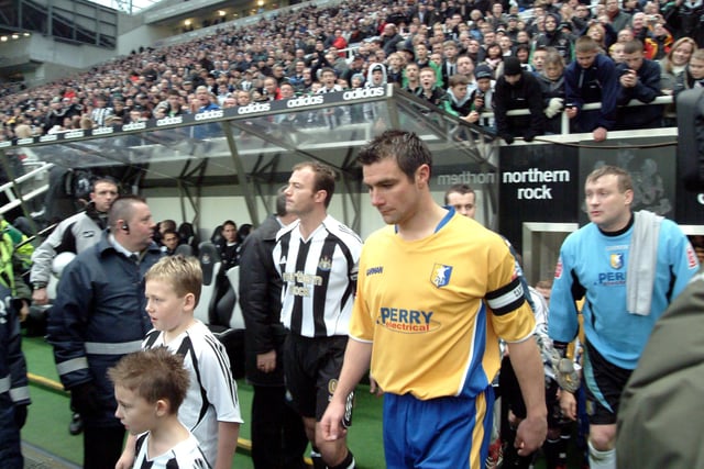 Stags captain Richie Barker walks out at St James park side by side with Alan Shearer.