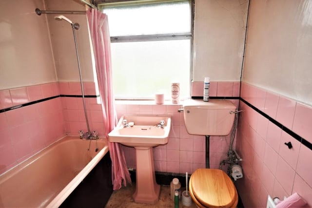 The Sutton bungalow's bathroom is a three-piece suite comprising a panelled bath, wash hand basin and low-flush WC. The walls are part-tiled.