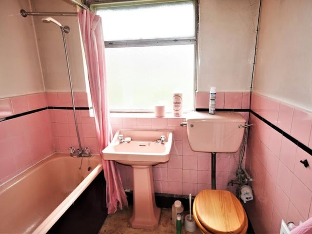 The Sutton bungalow's bathroom is a three-piece suite comprising a panelled bath, wash hand basin and low-flush WC. The walls are part-tiled.