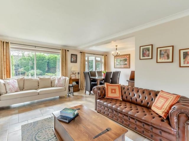 Our tour of the £649,950 Mansfield house begins in the luxurious, L-shaped open-plan living room and dining room. Windows to the front and back make it a bright space with a tiled floor, underfloor heating and coving to the ceiling. Sliding patio doors lead out to the rear garden.