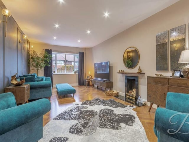 The living area oozes luxury, especially with its open fireplace, parquet floor and downlights. The window faces the front of the Hillsway Crescent house.