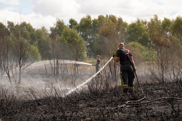 Firefighters tackle a grass fire in the Oak Tree area of Mansfield
