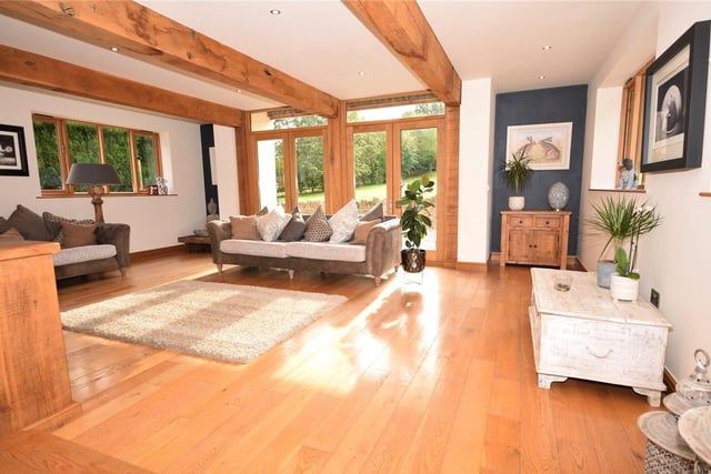 Next up is a handful of photos of the sunny living room at the £925,000 property. Eyecatching features include a beamed ceiling., a solid oak floor with underfloor heating and two sets of double doors that lead out to a patio.