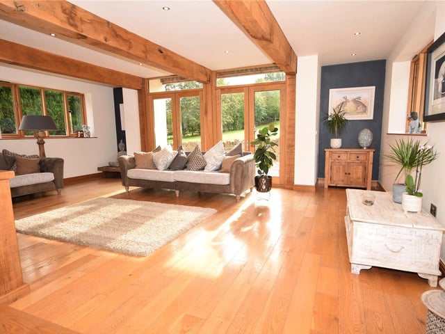 Next up is a handful of photos of the sunny living room at the £925,000 property. Eyecatching features include a beamed ceiling., a solid oak floor with underfloor heating and two sets of double doors that lead out to a patio.