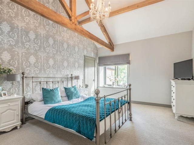 As we move upstairs, here is the master bedroom at the £435,000-plus property. A substantial space, it boasts a 13-foot high, vaulted ceiling and a superb king post truss.