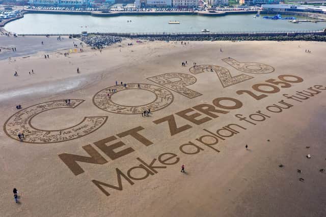 A giant sand artwork adorns New Brighton Beach to highlight global warming ahead of the COP26 global climate conference.