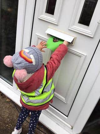 A youngster from Cherubs Wynndale nursery posts a homemade Christmas card.