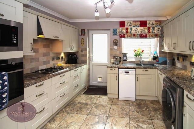 The kitchen at the £250,000-plus bungalow boasts a range of modern and matching wall and base units, with trendy work surfaces. Integrated appliances include a gas hob with extractor over.