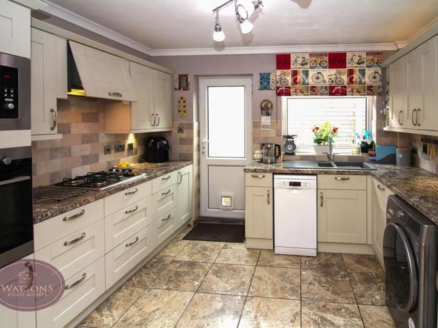 The kitchen at the £250,000-plus bungalow boasts a range of modern and matching wall and base units, with trendy work surfaces. Integrated appliances include a gas hob with extractor over.