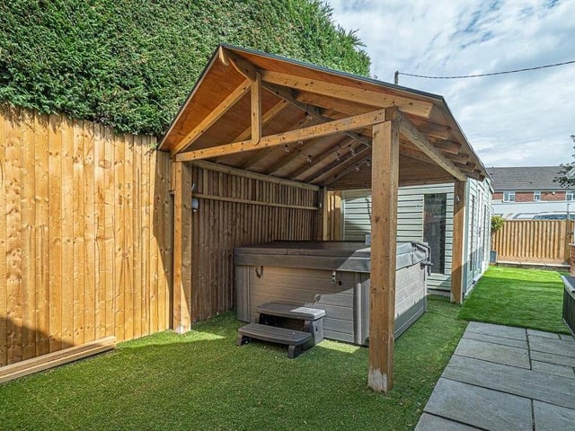 Added bonuses in the garden are a summer house, shed and covered area for a hot tub.