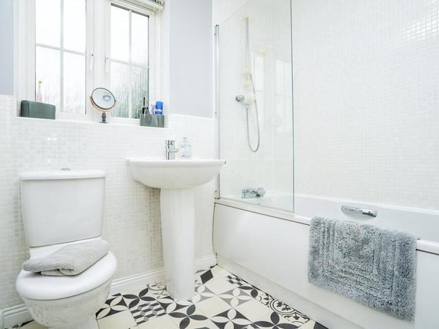 Time now to inspect the family bathroom. It is fitted with a bath and shower over, wash hand basin with mixer tap, WC and vinyl flooring.