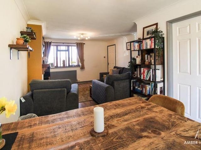 There is an abundance of space in the living room/diner, including for a dining table. The floor is laminated and there is a soft wood double-glazed window to the front of the property.
