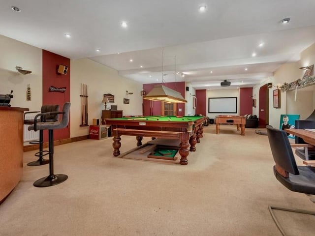 The lower ground floor is dominated by this huge games or entertainment room. So huge that there is space for a full-sized snooker table and a pool table. There is also a cinema space at each end.and a bar area.
