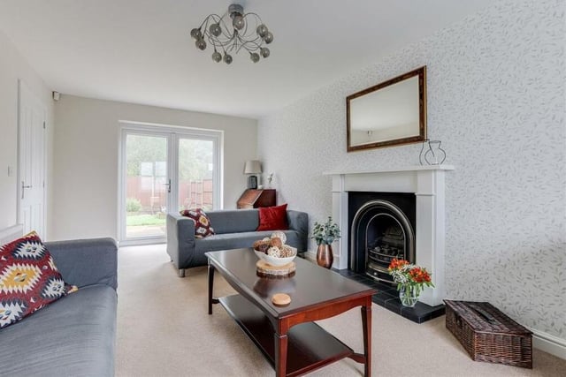 Let's begin our tour of the £325,000 Annesley home in this lovely and spacious living room. It features double French doors that provide access to the back garden.
