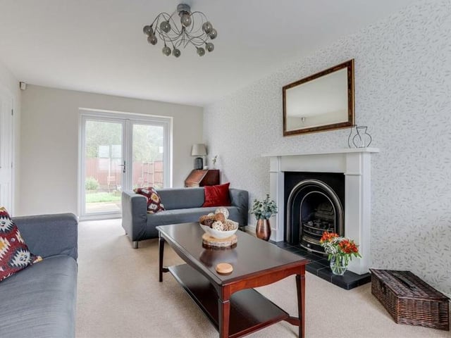 Let's begin our tour of the £325,000 Annesley home in this lovely and spacious living room. It features double French doors that provide access to the back garden.