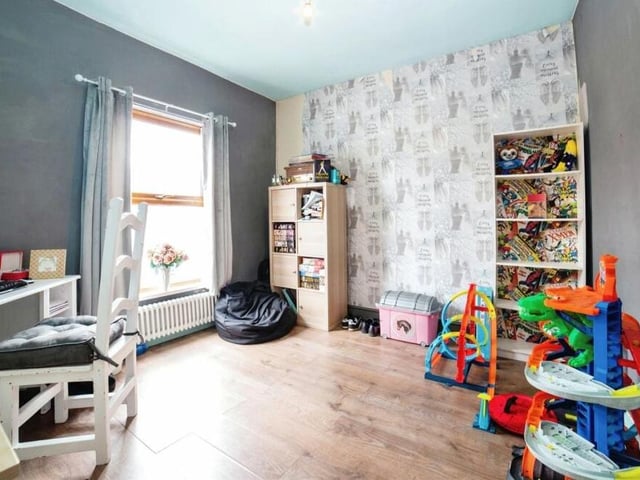 The versatile second bedroom, which also faces the front of the house, could be utilised as a children's play room or as a home office.