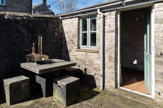 There is a stone outbuilding in the sunny, walled rear courtyard.