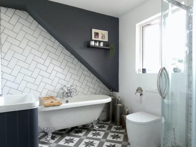 The master bedroom also includes this stylish, four-piece en suite, complete with a free-standing bath tub.