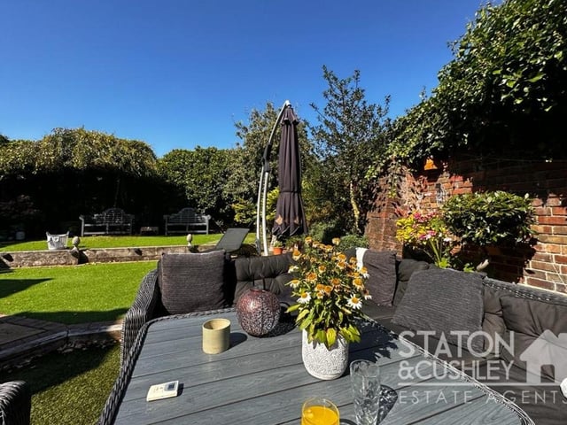 The well-established rear garden is a veritable sun trap and has been beautifully landscaped, with lawned areas and attractive borders.