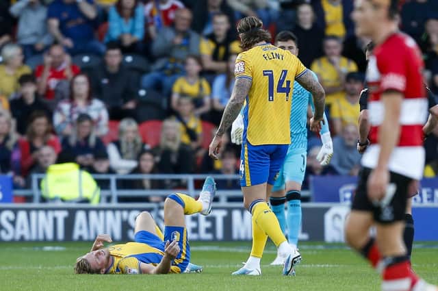 Mansfield Town defender Alfie Kilgour is injured during the Sky Bet League 2 match against Doncaster Rovers FC at the Eco-Power Stadium  
Photo Chris & Jeanette Holloway / The Bigger Picture.media
