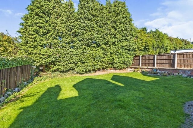 Mature shrubs, trees and fenced boundaries make the rear garden a secured and enclosed space