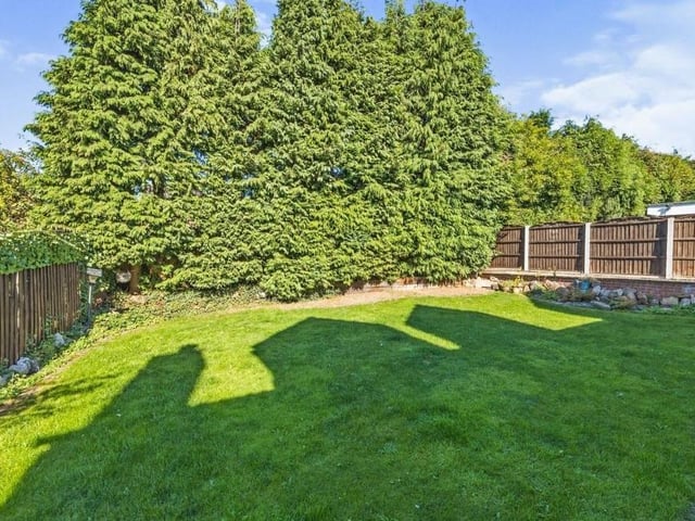 Mature shrubs, trees and fenced boundaries make the rear garden a secured and enclosed space