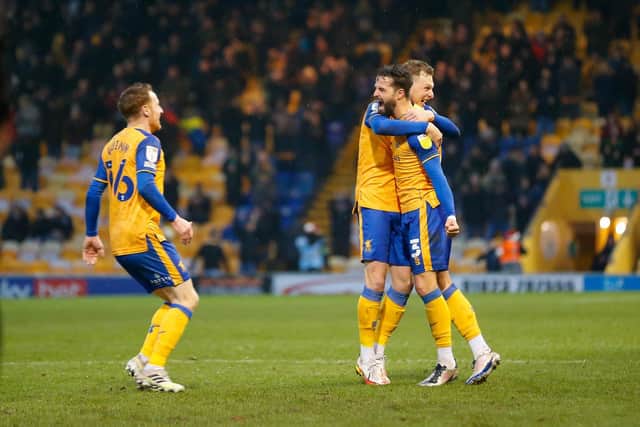 Mansfield Town defender Stephen McLaughlin celebrates his winning goal against Salford with team mates. Photo by Chris Holloway/The Bigger Picture.media