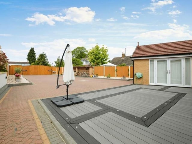 The last photo in our gallery shows the view from the front of the bungalow, looking down the driveway to the electronic gates.