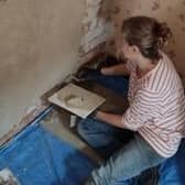 A volunteer carrying out plasterwork at the D.H. Lawrence Birthplace Museum