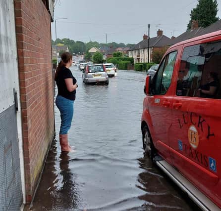 Photos taken near Spring Bank area, Sutton. One resident looks out over the flooded street.