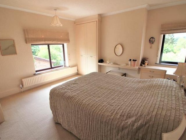 Another of the four bedrooms. All four have carpeted floors, while this one boasts fitted wardrobes.