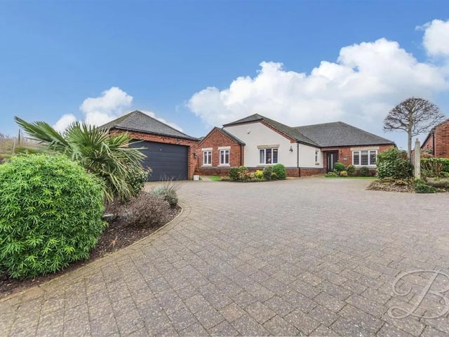 The impressive property has a large, standalone garage at the front and a generous driveway that provides ample parking.
