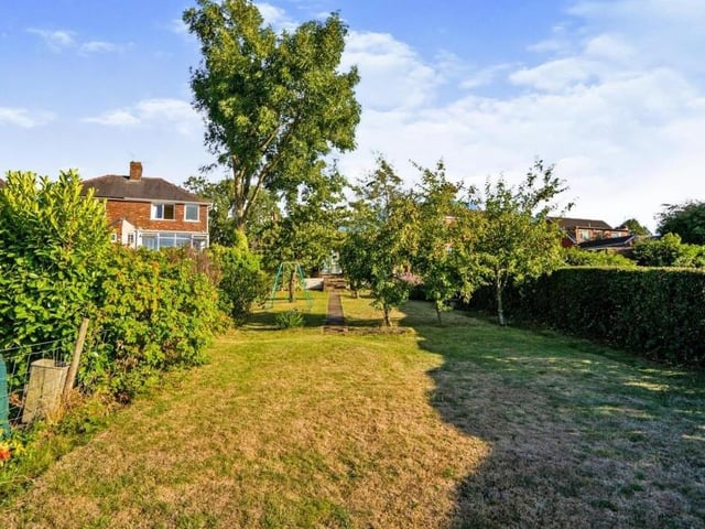 The lengthy, enclosed back garden is a lovely sight, with its lawn, trees, shrubs and bushes. A terrific family space.