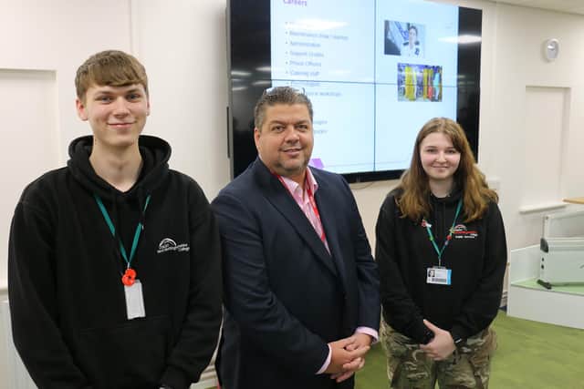 Students Reece Budd, left, and Brilie Burrow, right, with prison governor Philip Novis