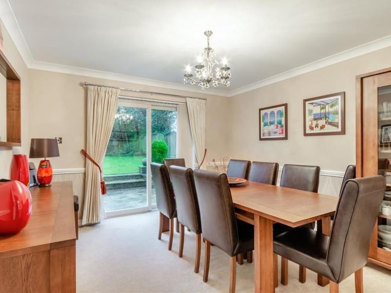 Next stop on our tour of the New Mill Lane house is the dining room. A pleasant space, it offers garden views thanks to double-glazed, sliding patio doors that lead outside.