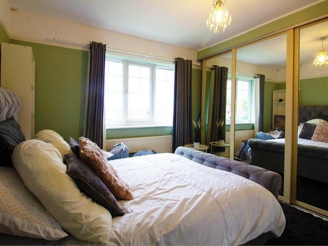 Moving on to the first floor now and, off the landing, is this first double bedroom, mirrors and all. It boasts fitted wardrobes, wood flooring, a radiator and window to the back of the property.