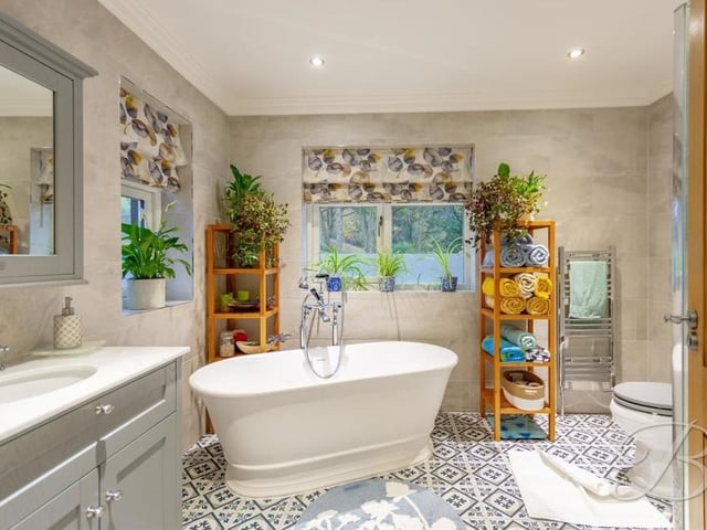 The family bathroom, to be found on the first floor, consists of a stylish four-piece suite, matching that of the en suite. It includes a free-standing bath, low-flush WC and hand was vanity unit. There's also full-height tiling, a chrome, heated towel-rail and downlights.