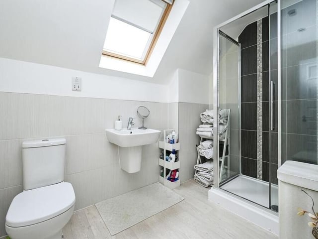 The master bedroom has access to this stylish en suite shower room, complete with walk-in shower cubicle, wash hand basin and low-flush WC.