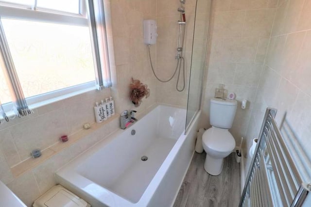 The first floor houses the main family bathroom. It comprises a white three-piece suite that includes a double-ended bath with shower over.