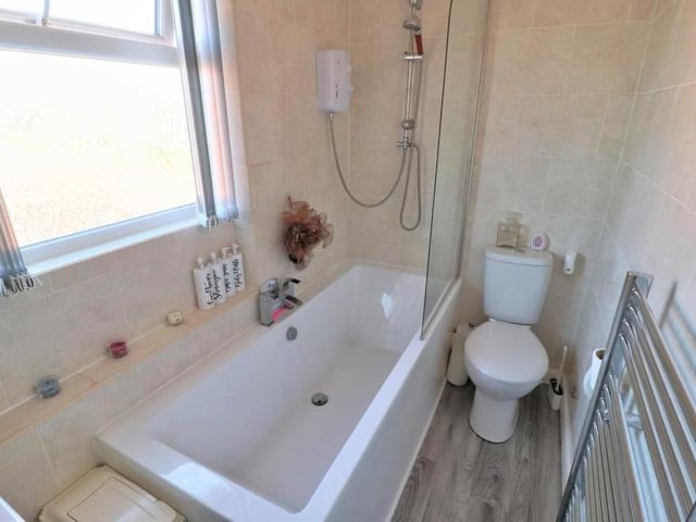 The first floor houses the main family bathroom. It comprises a white three-piece suite that includes a double-ended bath with shower over.