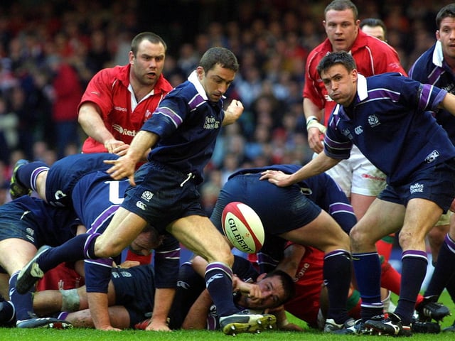 Bryan Redpath, watched by John Leslie, clears his lines. The scrum-half was skipper in Cardiff, the last Scotland captain to win in Wales.
