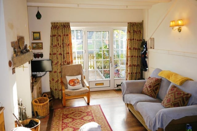 Let's begin our tour of the Turnerwood cottage in the charming lounge, the room you enter through the double-glazed front door. Its wooden laminate floor and ceiling with exposed beams give it plenty of character.