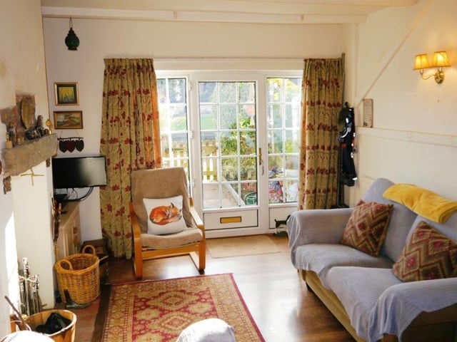 Let's begin our tour of the Turnerwood cottage in the charming lounge, the room you enter through the double-glazed front door. Its wooden laminate floor and ceiling with exposed beams give it plenty of character.