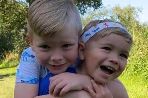 Noah Brett, seven, is raising money to help his younger brother Max, three, learn to speak.