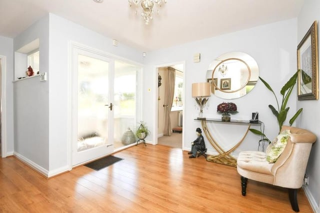 The entrance hallway is also a delightful space. Warm and welcoming, it features laminate flooring, two storage cupboards and a pull-down ladder giving access to the loft.