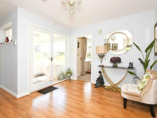 The entrance hallway is also a delightful space. Warm and welcoming, it features laminate flooring, two storage cupboards and a pull-down ladder giving access to the loft.