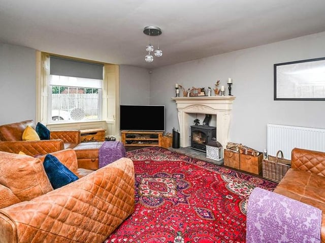 A second shot of the comfortable and spacious lounge. Not far away is a utility room with a range of modern units and plumbing for a washing machine.